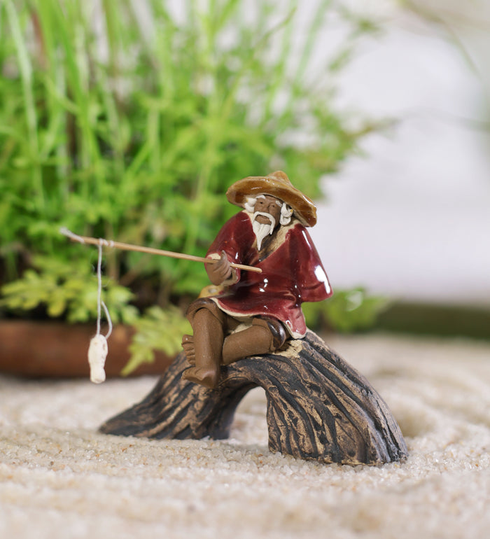 bonsai tree with fisherman Old Fisherman Sitting On U Rock With Fishing Rod