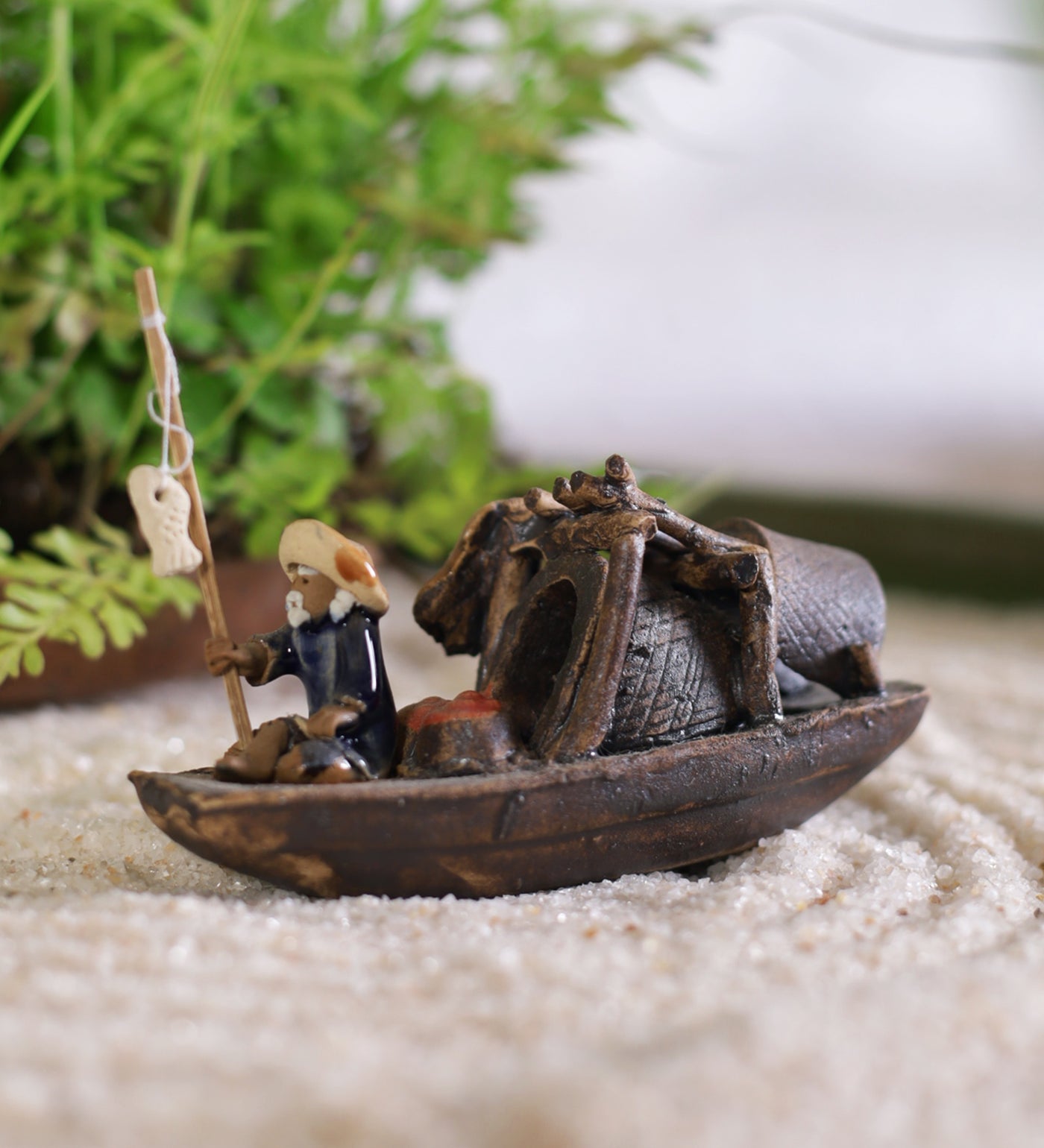 Old fisherman in blue sitting on boat with fishing rod – Gaia Pottery In