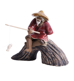 Old fisherman sitting on u rock with fishing rod
