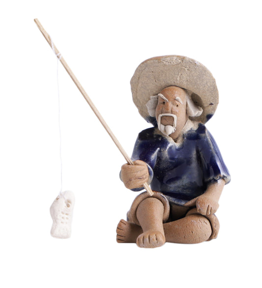 Old Fisherman In Blue On Ground With Fishing Rod